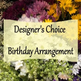 Mixed bouquet of daisies and chrysanthemums with a birthday sign