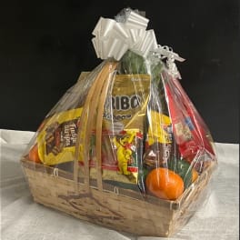 Gift basket with candy and fruit wrapped in clear cellophane