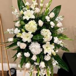 Tall white floral standing arrangement on an easel
