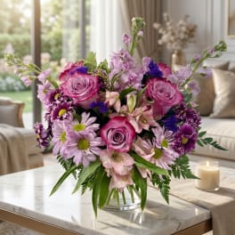 Pink and purple mixed bouquet in a clear glass vase