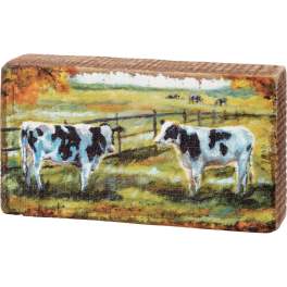 Rectangular decorative block with a painted cow scene