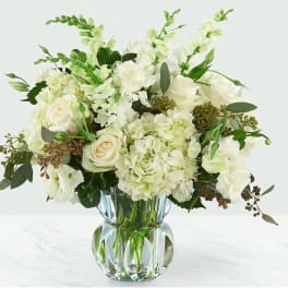 White floral arrangement in a clear glass vase