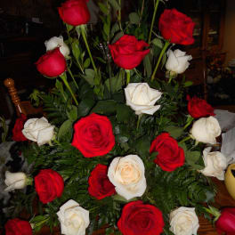 Bouquet of red and white roses with fern foliage