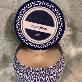 Blue and white scented candle in a patterned tin with the lid open
