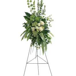 Tall white rose and greenery standing spray on an easel