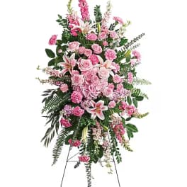 Tall pink floral standing spray on an easel