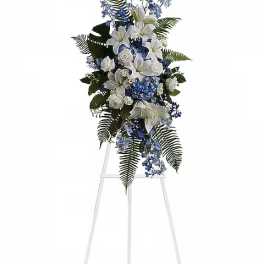 White and blue floral standing spray on an easel