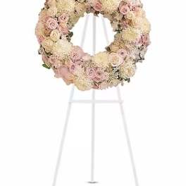 Pastel floral wreath on a white stand
