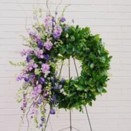Purple floral wreath on a metal stand