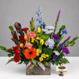 Colorful mixed flower arrangement in a rustic wooden box