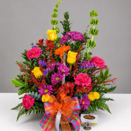 Colorful mixed bouquet with roses, chrysanthemums, carnations, and a plaid ribbon bow