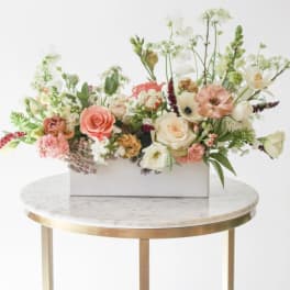 Mixed floral arrangement in a white rectangular box