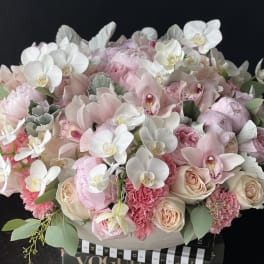 Large pastel bouquet of pink and white flowers in a box