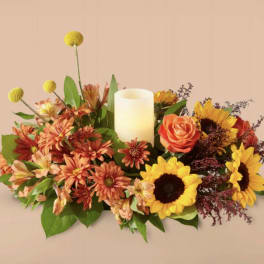 Autumn floral centerpiece with a candle and sunflowers