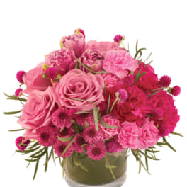 Pink roses and carnations in a glass vase