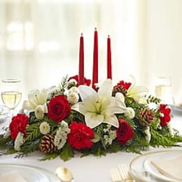 Red and white floral centerpiece with three red candles