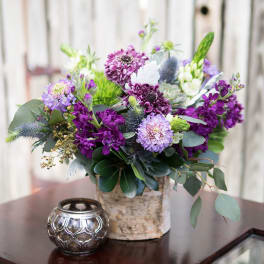 Purple and lavender bouquet in a birch-style vase with eucalyptus