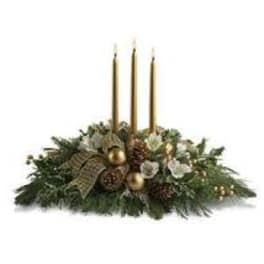 Holiday centerpiece with three gold candles and evergreen decor
