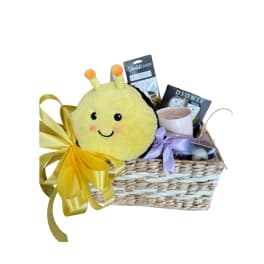 Gift basket with a plush bee, candle, and packaged items
