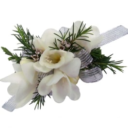 White floral wrist corsage with silver ribbon