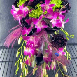 Bright pink orchids with green and purple accents in a cascading arrangement