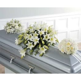 White floral sprays arranged on a gray casket