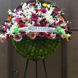 Mix spring flowers and orchids on half moon wreath - F35013