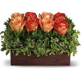 Arrangement of peach and red roses in a rectangular wooden box