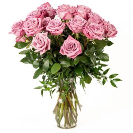 Tall arrangement of pink roses in a clear glass vase