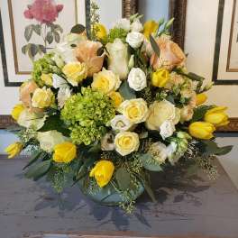 Mixed bouquet of yellow and white flowers in a low vase