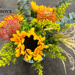 Bright mixed bouquet with a sunflower and pink, orange, and yellow blooms