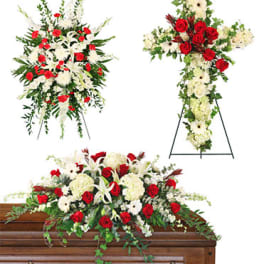 Floral funeral casket spray and standing cross arrangements in red and white