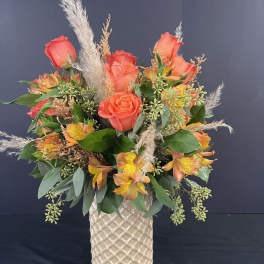 Orange rose and alstroemeria arrangement in a textured vase