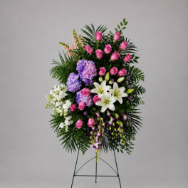 Standing floral spray with pink roses, white lilies, and purple hydrangeas