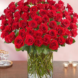 Large bouquet of red roses in a clear glass vase