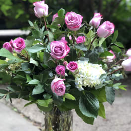 Pink roses and white hydrangea in a clear glass vase