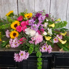 Mixed bouquet with sunflowers, pink roses, lilies, and purple flowers