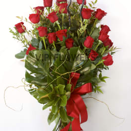 Bouquet of red roses with greenery and a red ribbon