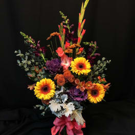 Tall mixed bouquet with yellow gerbera daisies in a vase