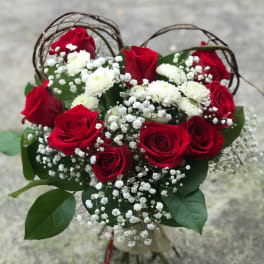 Bouquet of red roses and white baby's breath with greenery