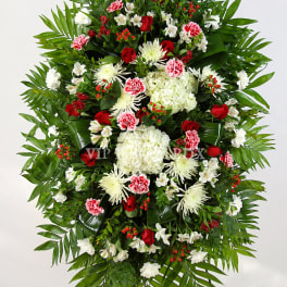 Large standing floral spray with red, white, and pink flowers