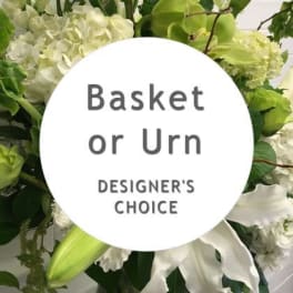 White and green floral basket arrangement with a designer's choice sign