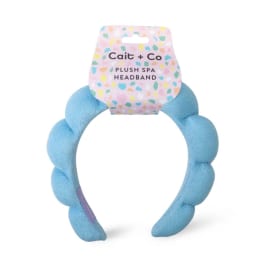 Blue plush spa headband with a retail tag