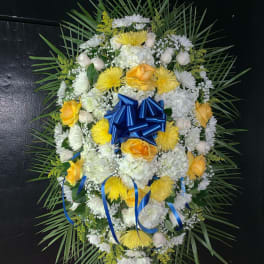 Oval floral wreath with yellow and white flowers and a blue bow