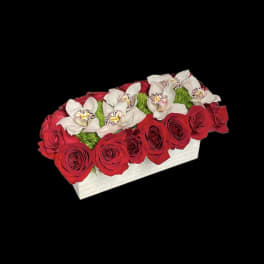 Red roses and white orchids in a white rectangular box