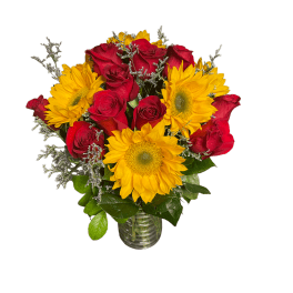 Bouquet of red roses and yellow sunflowers in a glass vase