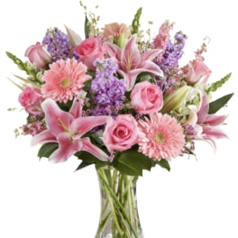 Pink and purple mixed bouquet in a clear glass vase