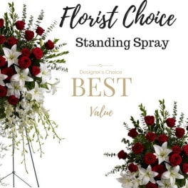 Standing spray of red roses and white lilies on a metal easel