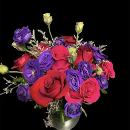 Bouquet of red and purple roses in a silver vase