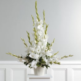 Tall white floral arrangement in a ribbed ceramic vase